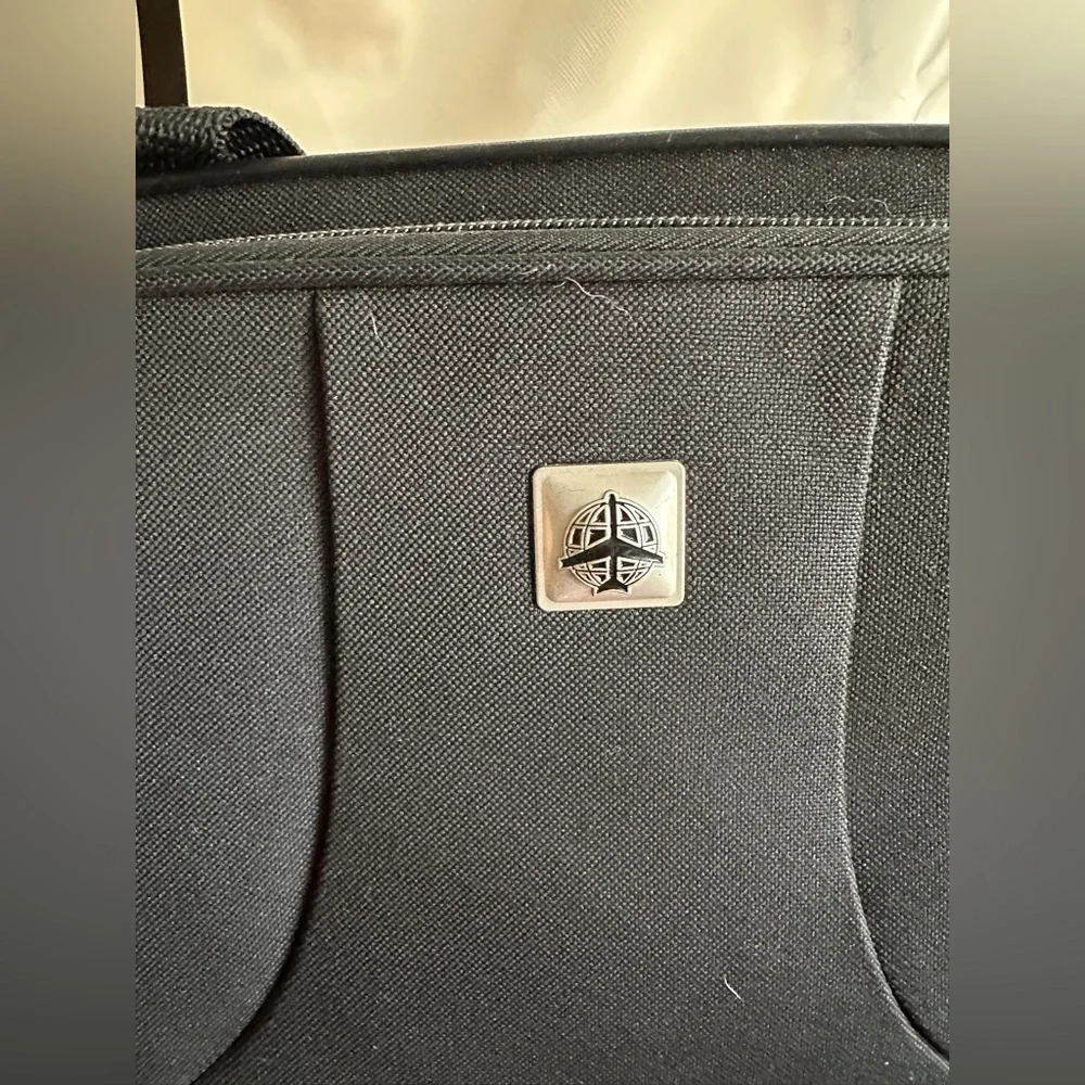 Men’s minimalist black carrying bag for travel or everyday use. Airplane logo.